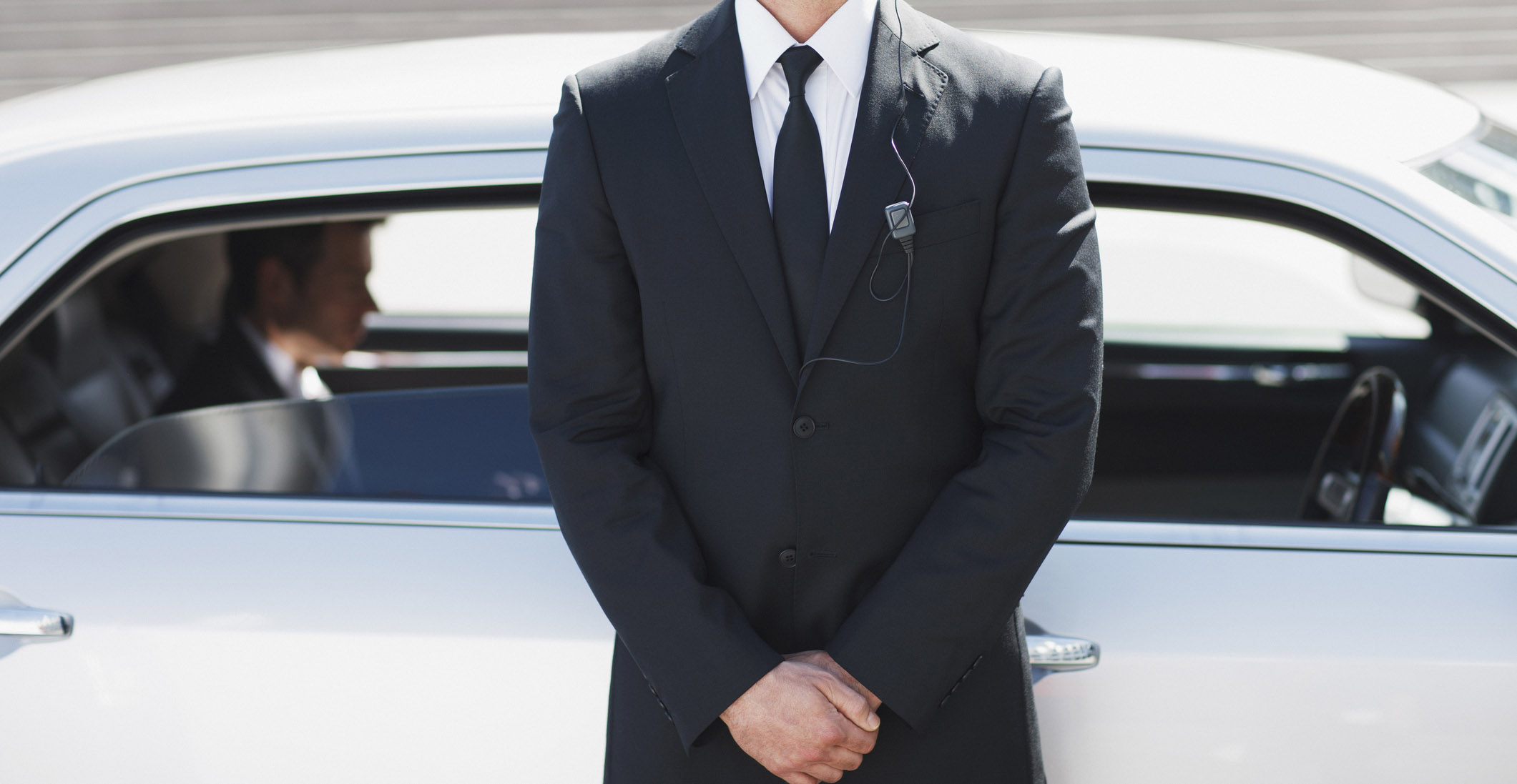 Security guard standing by car Security guard standing by car